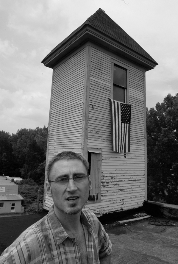 David Fairbanks Ford stands in front of the tower of the Fire Station Building in White River Junction in July, 2003. Photo, Jack Rowell.